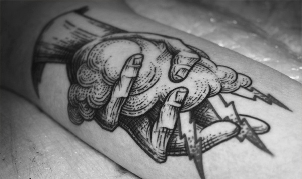 alex tabuns hand holding cloud tattoo