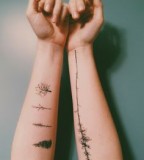 beautiful tattoo placement trees and leaves on inside arms