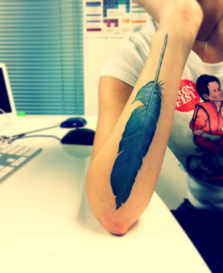blue ink tattoo feather arm piece
