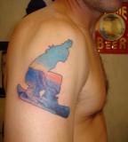 blue ink tattoo snowboarder scene on arm