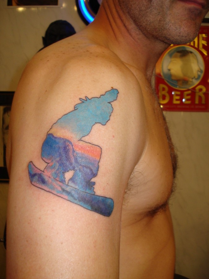 blue ink tattoo snowboarder scene on arm