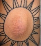 elbow tattoo sun
