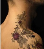 flowers and bugs neck and shoulder tattoo