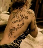 girly tattoo bindweed with flowers on back