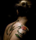 girly tattoo red flower and leaves on shoulder and back