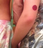 green tattoo buttons on arms for couple