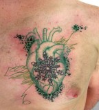 green tattoo heart with snowflake on chest