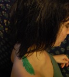 green tattoo redwood leaf on shoulder