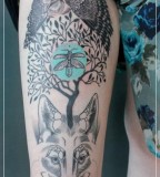 jessica mach tattoo bird tree and wolf composition on leg