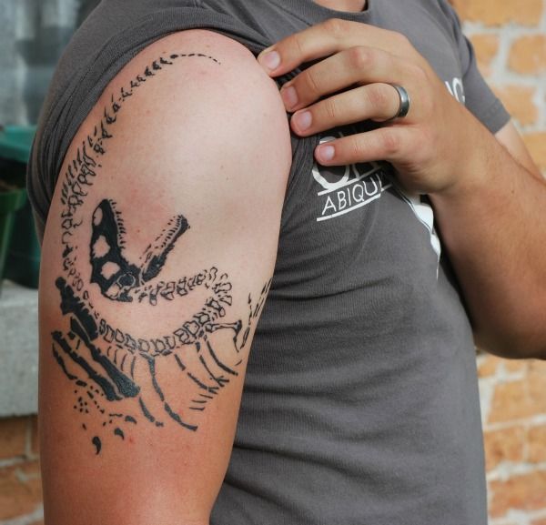 Arm dinosaur tattoo