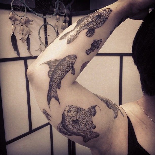 Arm fishes tattoo