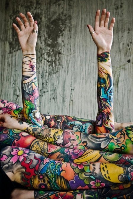 Arms of colorful tattoos