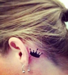 Black crown tattoo near ear