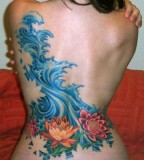 Blue and colorful flowers back tattoo