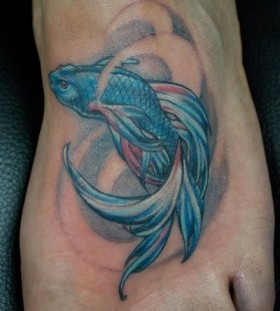 Blue fish tattoo on foot