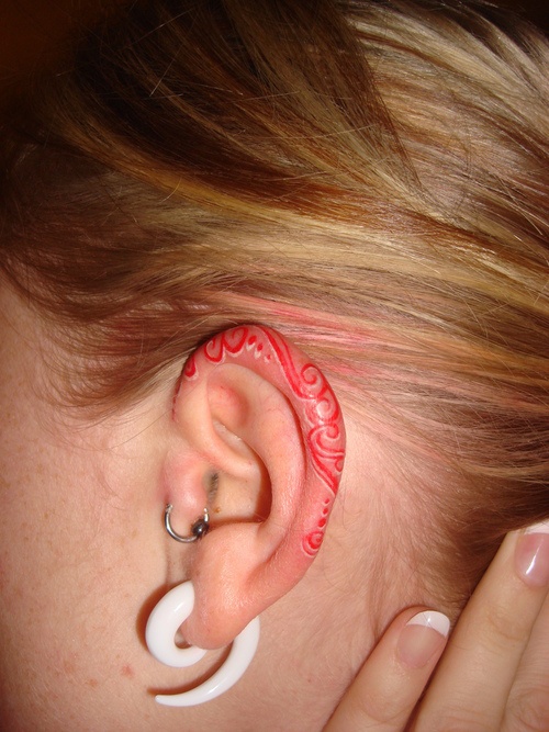 Ear red tattoo