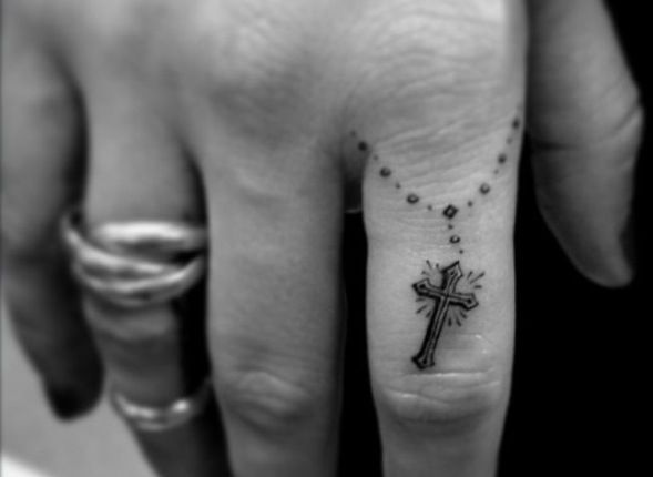 Finger cross religious tattoo