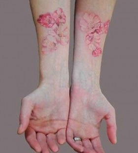 Flowers on arm pink tattoo