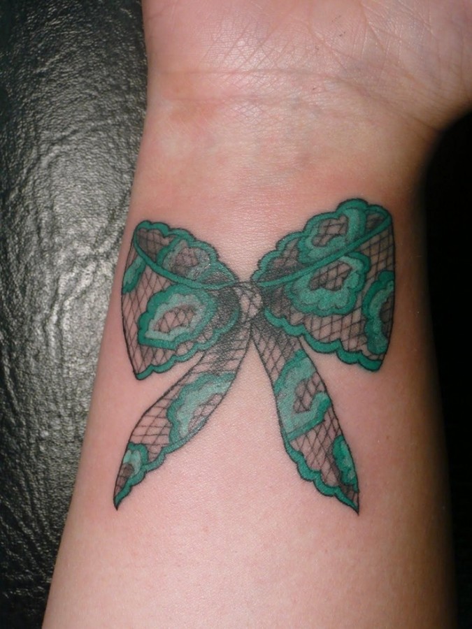 Green bow lace tattoo