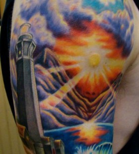 Lighthouse with sunset tattoo by Sean Ambrose