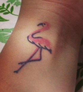 Pink and black flamingo tattoo on hand