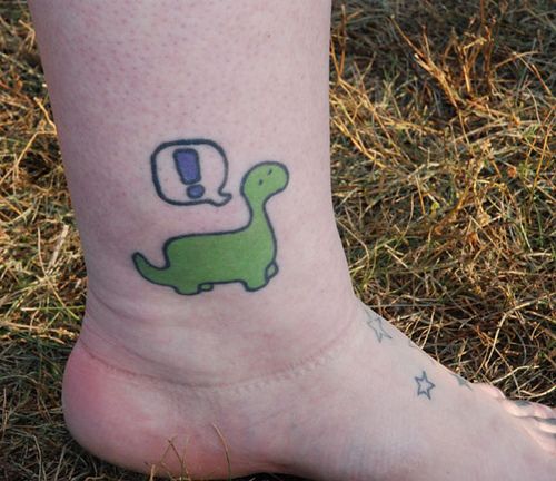 Pretty green dinosaur tattoo