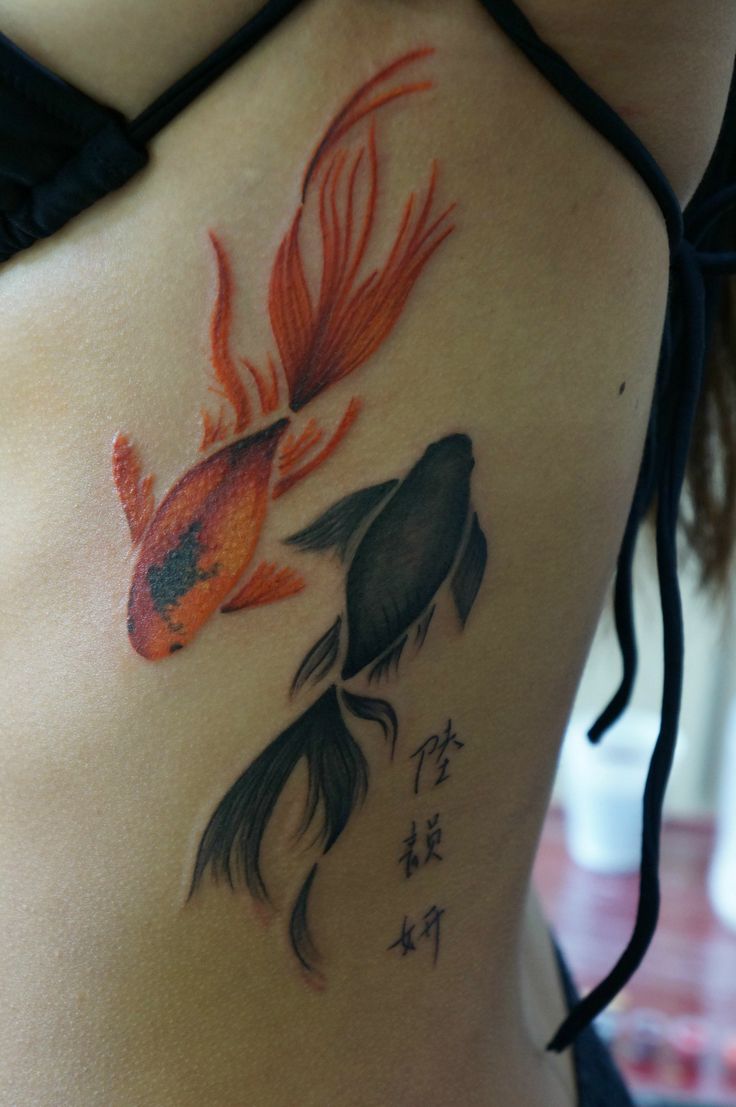 Red and black fish tattoo
