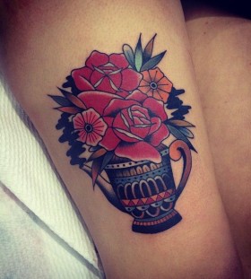 Red flowers tattoo by Kirk Jones