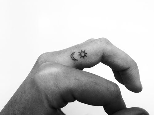 Simple finger sun tattoo