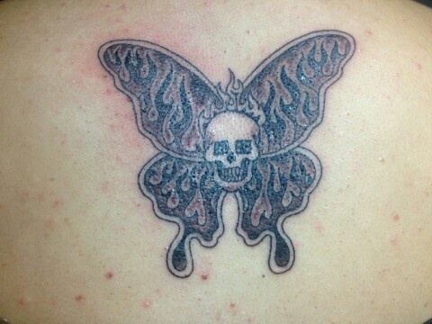 Skull and butterfly tattoo by Duane