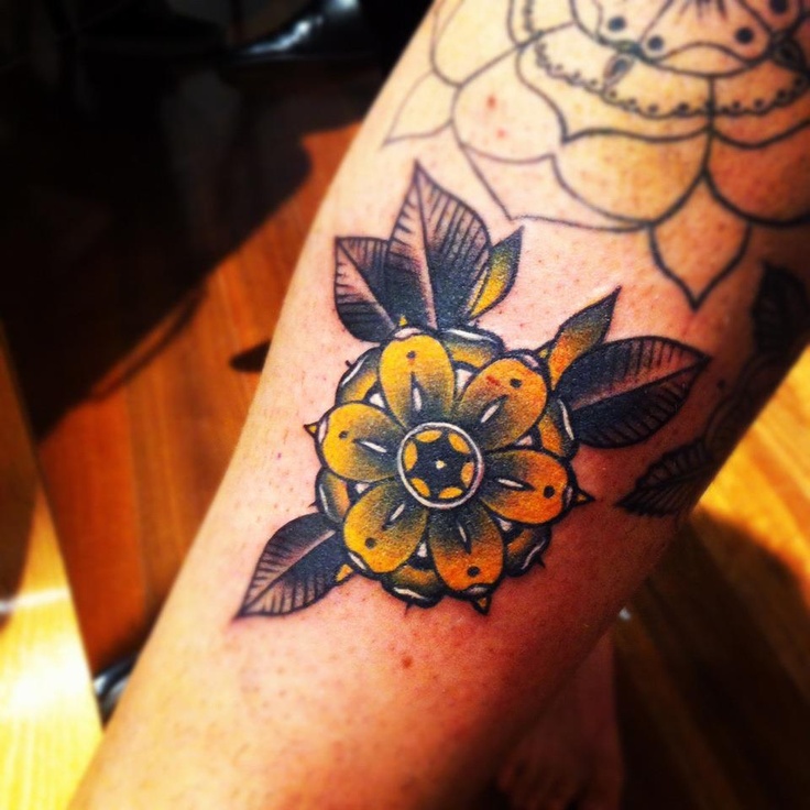Yellow flower tattoo by Pari Corbitt