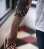 alice carrier tattoo black flower on arm