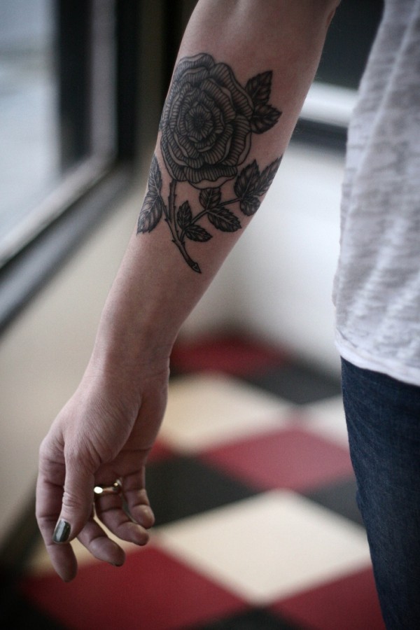 alice carrier tattoo black flower on arm