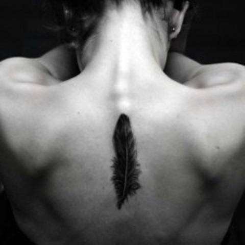 black ink elegant balck feather tattoo on back