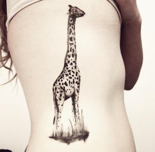 black ink giraffe tattoo on ribs