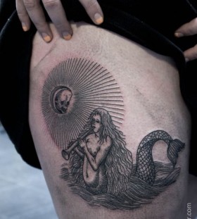 black ink siren tattoo on leg