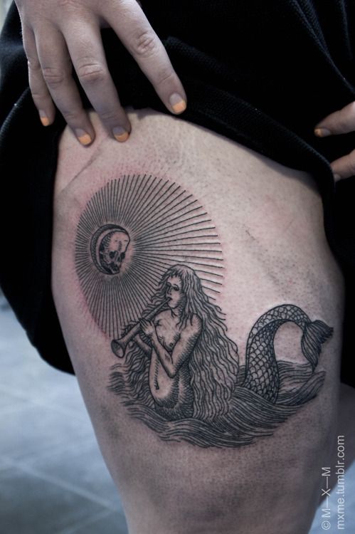 black ink siren tattoo on leg