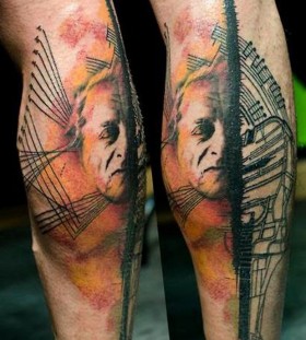 man's face tattoo on leg by klaim