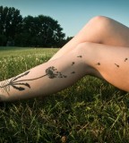 modern tattoo dandelion on leg