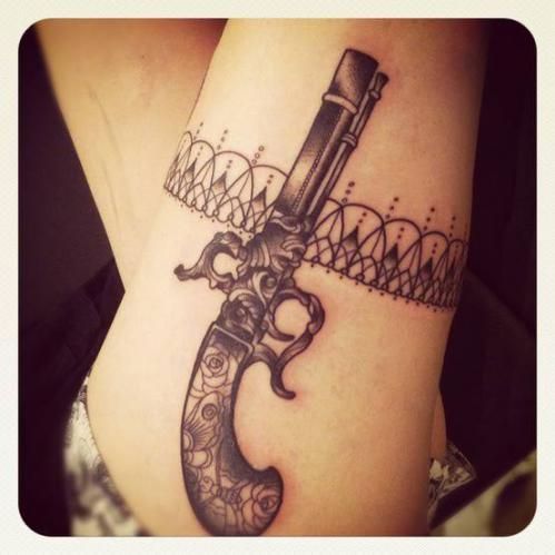Black gun tattoo
