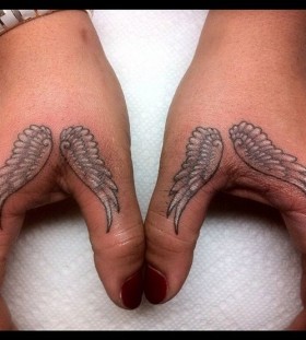 Fingers angel wings tattoo