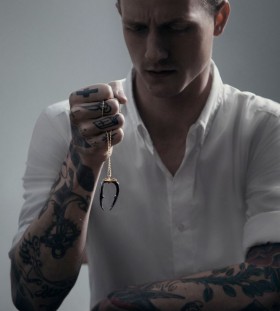 Man with tattoos and necklace