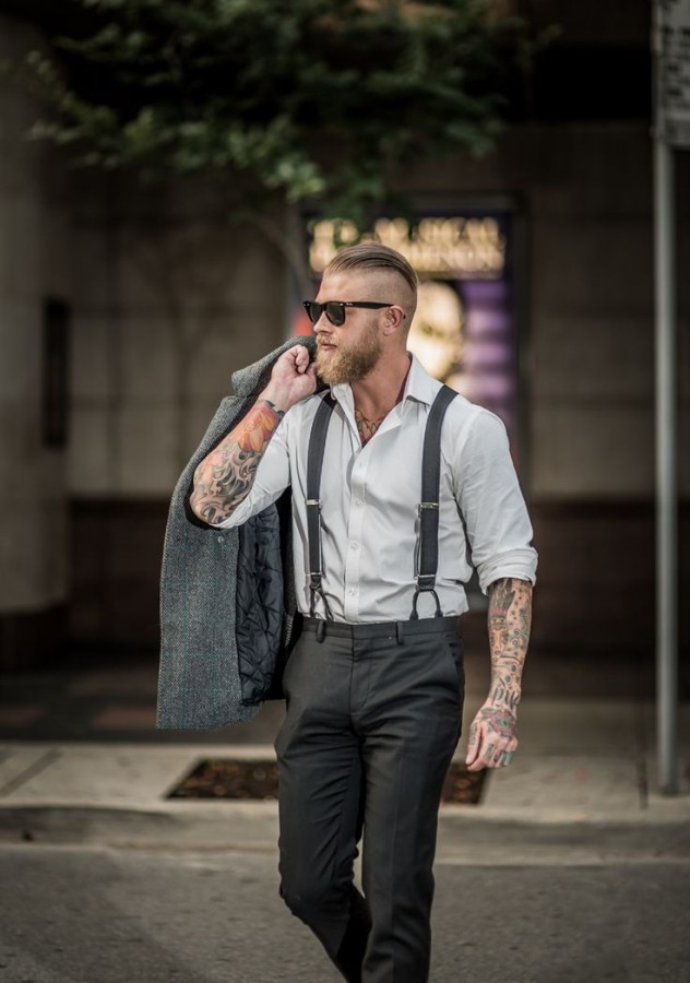 Man with tattoos in a suit