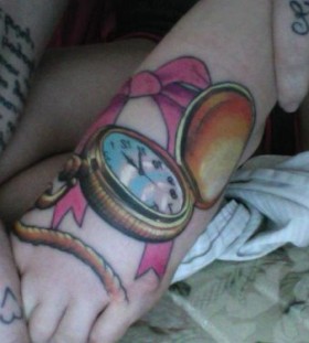 Pink clock tattoo