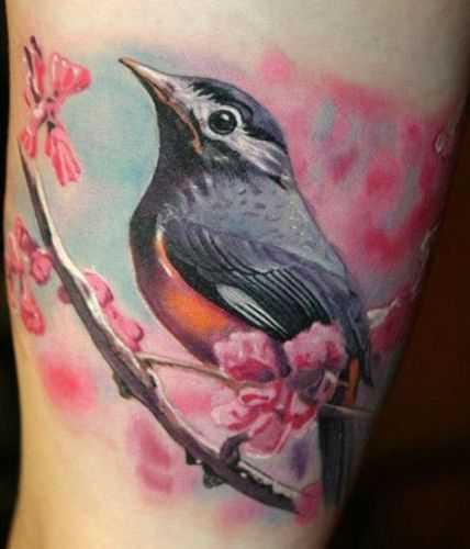 Pretty bird photorealistic tattoo