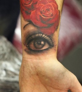 Red roses and eye tattoo