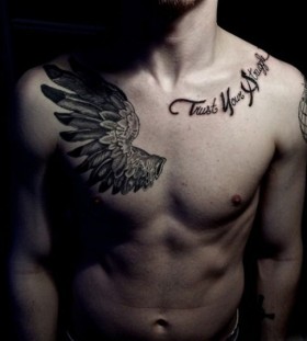Wings chest tattoo