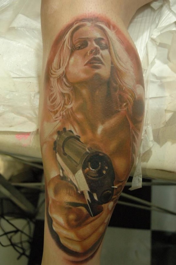 Woman and gun photorealistic tattoo