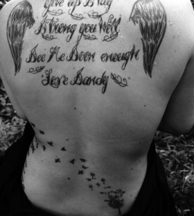 Words and angel wings tattoo