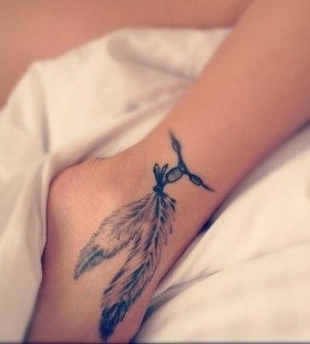 black feather tattoo on anckles